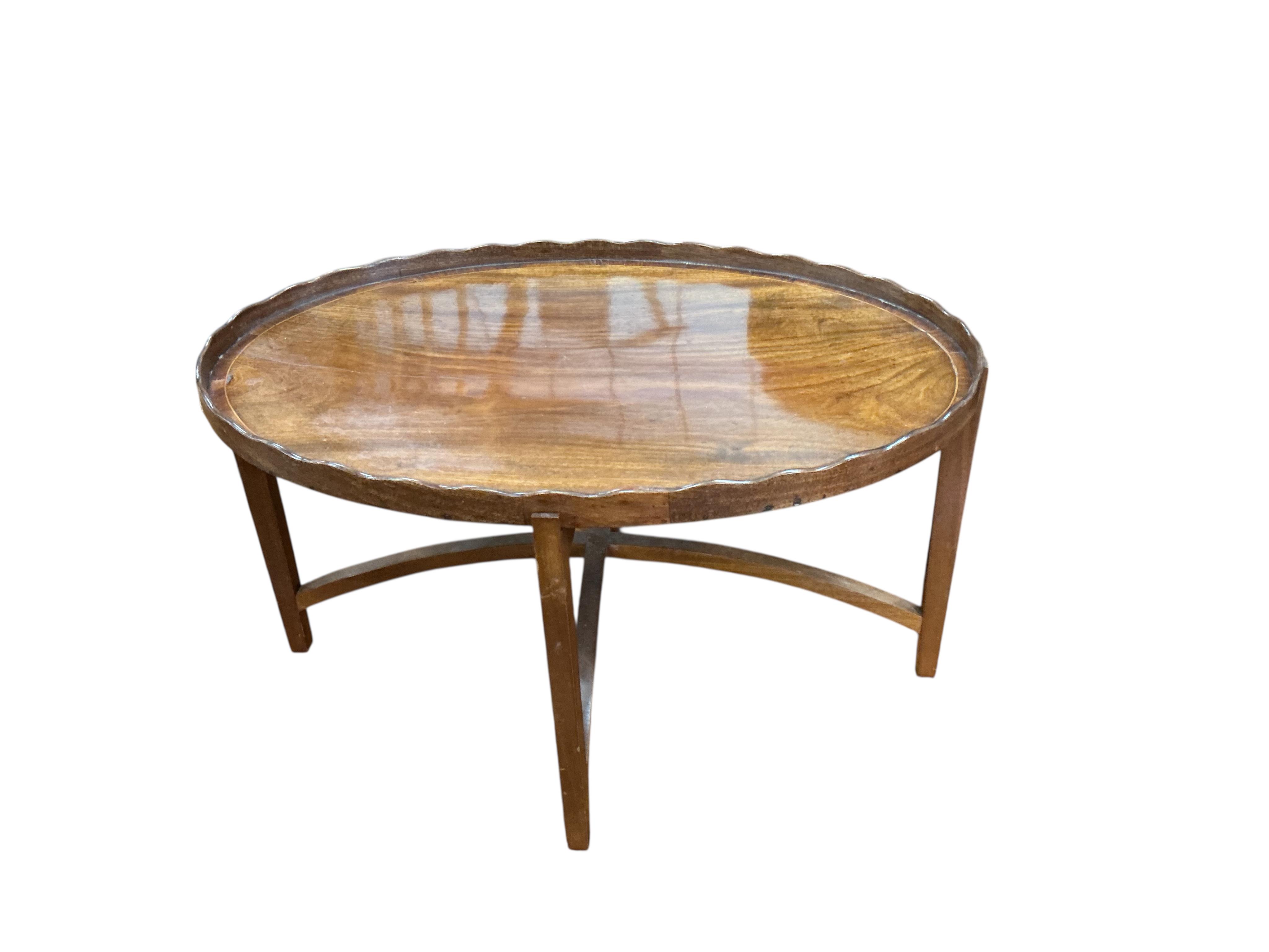 A George III oval mahogany tray on later 'X' framed stand, width 48cm, depth 39cm, height 33cm